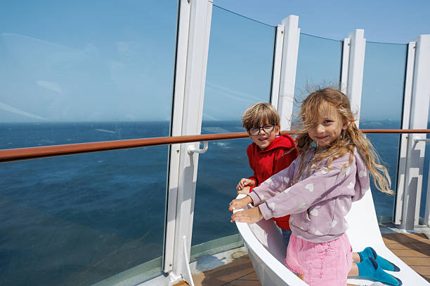 istock Smiling children explore the cruise ship aboard an adventure 2250615208