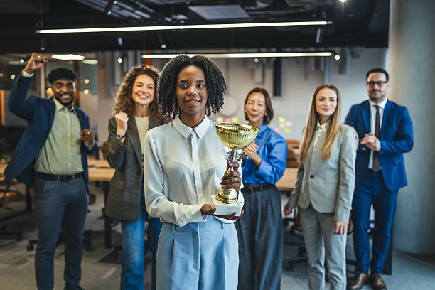 istock Business team celebrating achievement with a winning trophy 2250615776