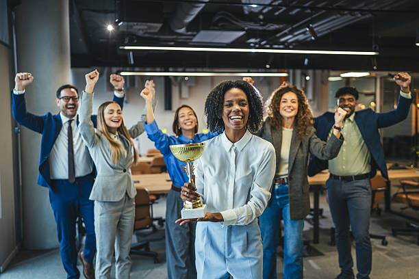 istock Business team celebrating achievement with a winning trophy 2250616137