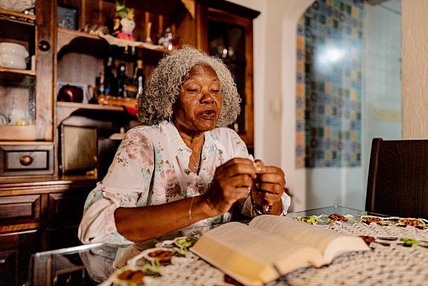 An old woman praying. Close-up. Nursing home