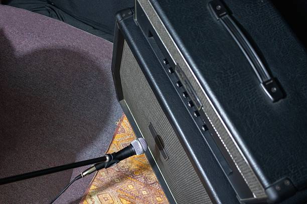top view of a microphone next to a guitar amplifier