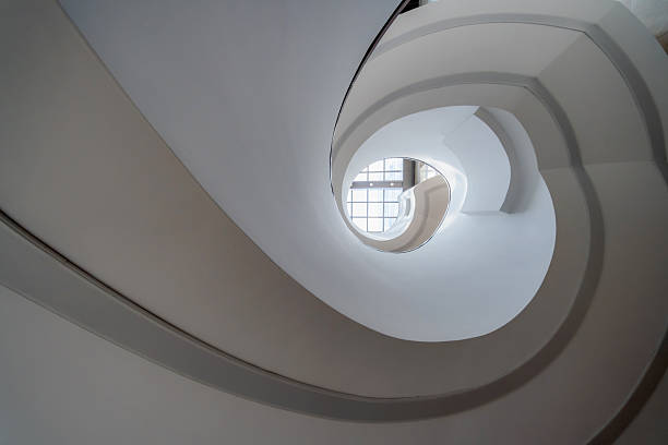 Bright indoor spiral staircase viewed from bottom to top