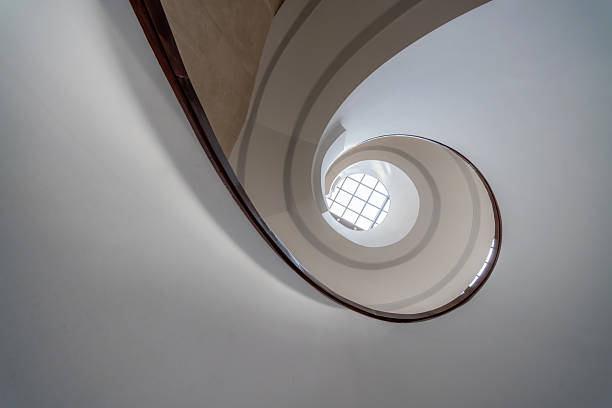 Bright indoor spiral staircase viewed from bottom to top