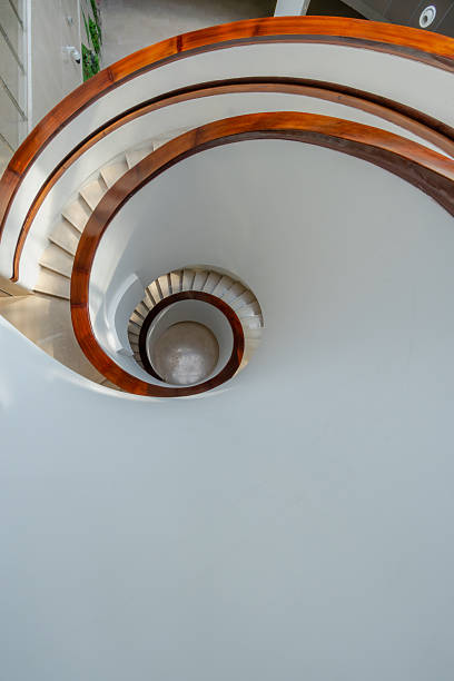 istock Overlooking the bright indoor spiral staircase 2250617286