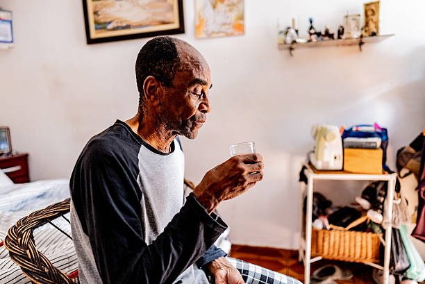 istock Senior man drinking water at home 2250617297