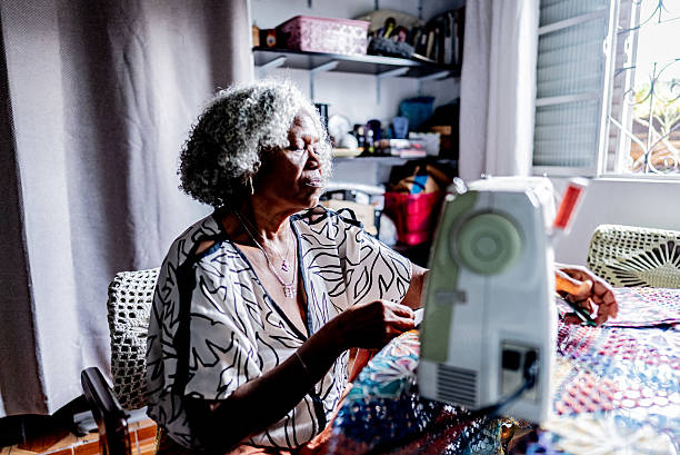 istock Senior woman sewing using sewing machine at home 2250617314