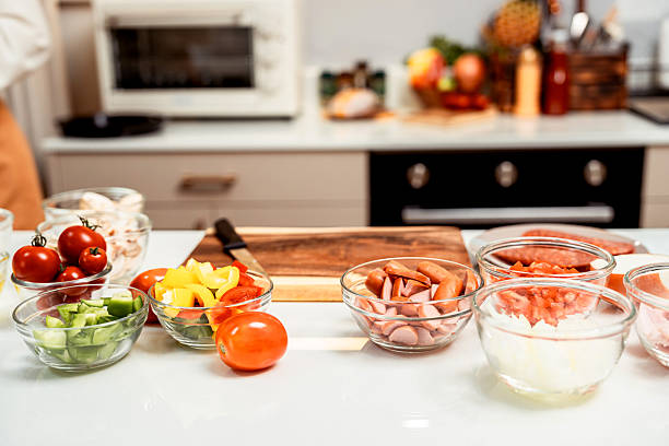 istock Homemade pizza at home kitchen with fresh organic vegetables. 2250617316