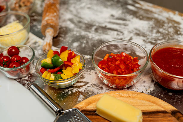 istock Homemade pizza at home kitchen with fresh organic vegetables. 2250617326