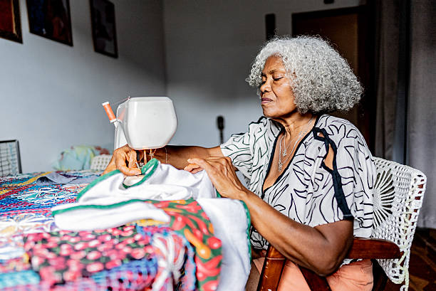 istock Senior woman sewing using sewing machine at home 2250617329