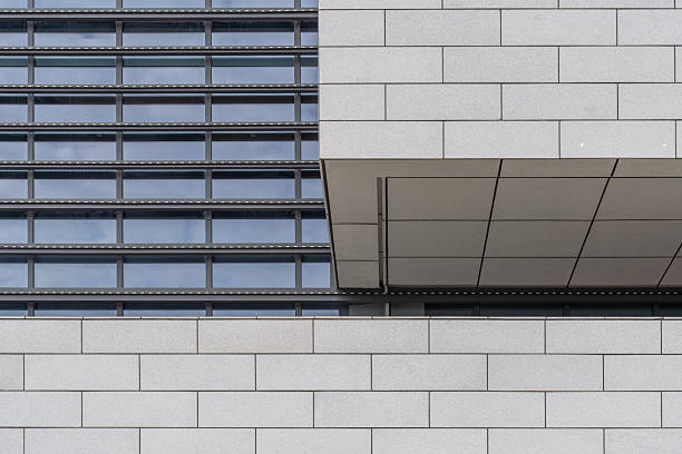 Close-up of glass doors, windows, and tiles in modern architecture.