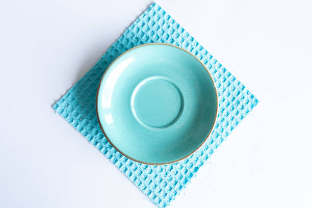 Waffle cotton towel used as a stylish table accessory with a ceramic plate. Modern composition showcasing texture, color harmony, and home lifestyle aesthetics.