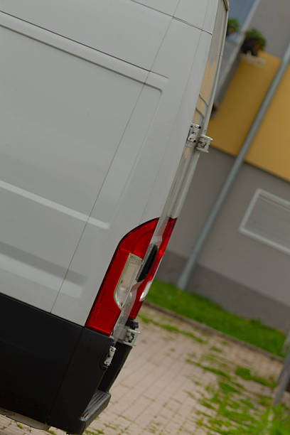 istock Damp bumper and tail light seen on delivery van in downtown area 2250622145