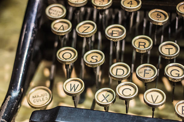 A close-up of a vintage French typewriter with round beige keys and black letters, highlighting retro design and tactile craftsmanship.