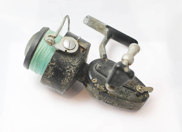 close-up of an old fishing reel on a white background
