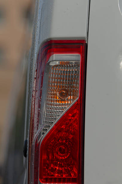 istock Nighttime urban setting with illuminated and wet vehicle features 2250623463