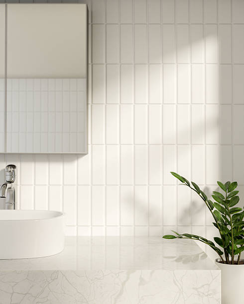 istock White marble sink counter table under mirror aside houseplant in bathroom with sunlight on tile wall 2250626487