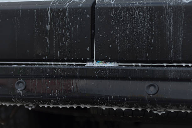 istock Water streaming down bumper seam revealing runoff streaks and textured joint 2250626838
