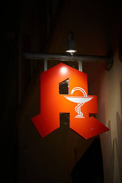 Luneburg, Germany – October 30, 2025: dirty neon sign of a pharmacy in the city of Lüneburg, Luneburg in Germany at night