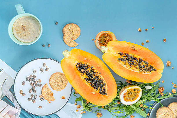 istock Papaya, passion fruit, rucola and granola on a blue background. 2250630573