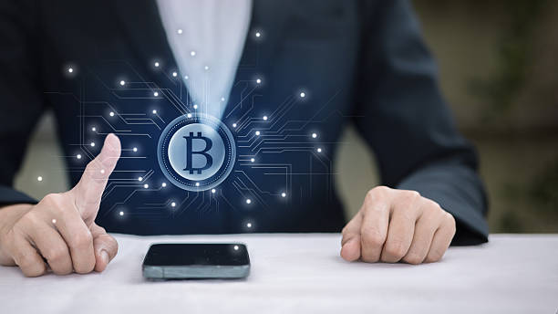 istock Businessman Touching Digital Bitcoin Icon on Smartphone 2250630981
