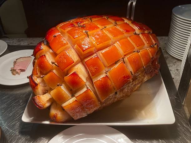 Honey glazed ham on white plate in restuarant for celebration, Christmas, Thanksgiving, Easter