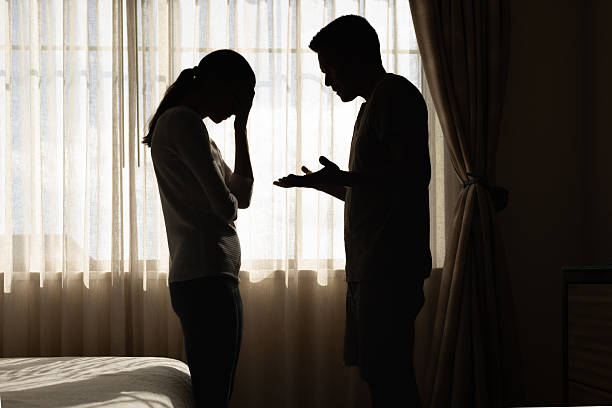 istock Silhouette of a Distressed Couple Arguing in a Bedroom Setting 2250641693