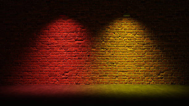 istock Brick Wall Background, Rough Concrete With Glowing Red Yellow Lights 2250643314