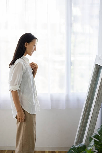 istock Woman Checking Outfit in Front of Mirror 2250644640