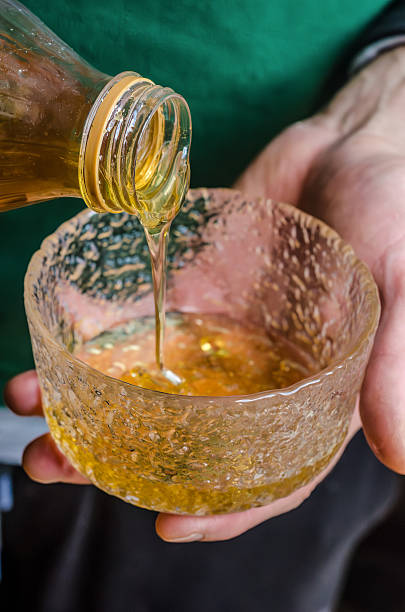 Pouring honey into Bowl During Cooking Prep