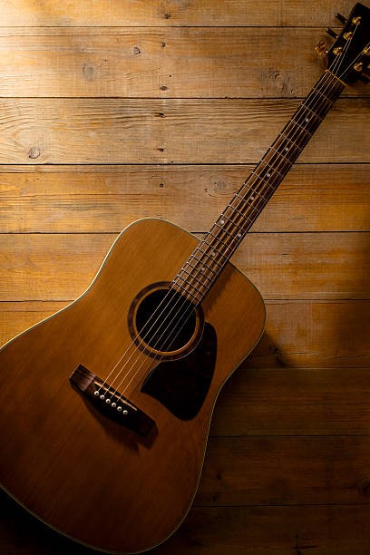 istock Acoustic guitar on a wooden background with space for copy 2250648395