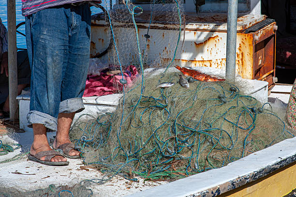 Blue fishing net on ground prepared for mending