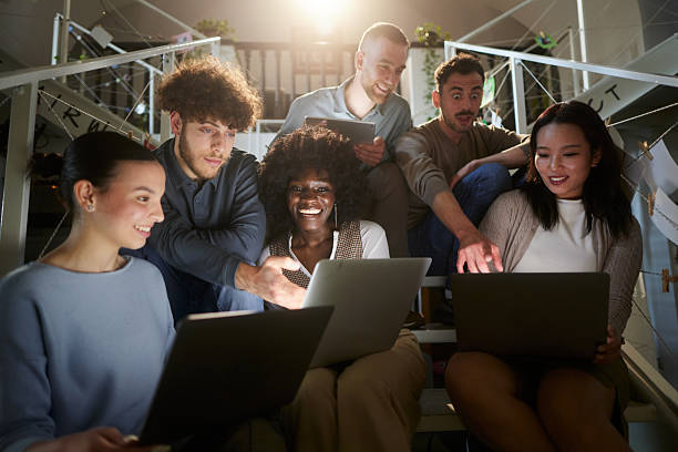 istock Multiracial group of happy freelancers using computers in a hallway. 2250649822