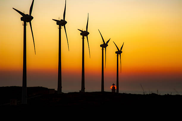 Windmills sunset and Bozcaada lighthouse silhouette