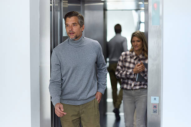 istock Mid adult man exiting the elevator in a hallway. 2250653335