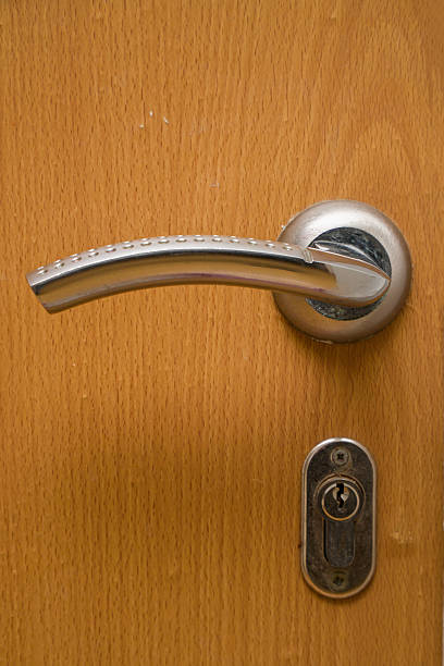 istock Door handle and keyhole on wooden door 2250653578