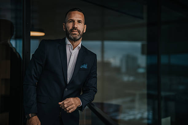 istock Confident businessman standing in modern corporate office looking at camera 2250653900