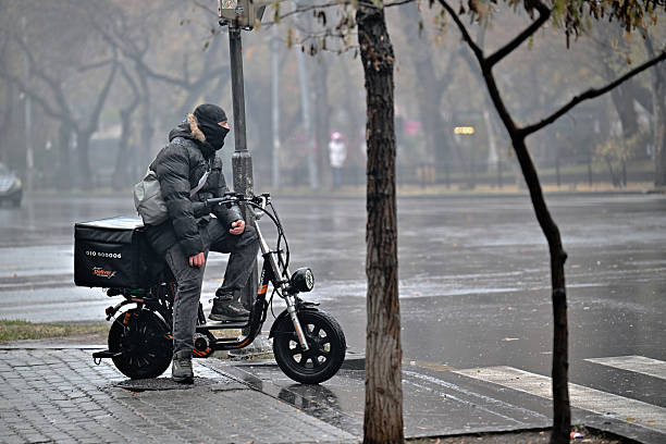 A worker organizes shared bicycles in Beijing, China on October 10th, 2023. The image shows an efficient bike-sharing service in a urban setting.
