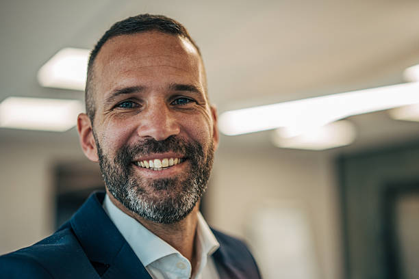 istock Confident businessman smiling in modern office environment 2250654761