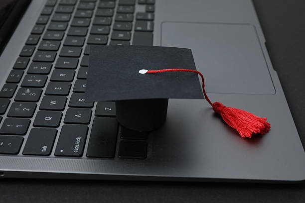 istock Graduation concept. Flat lay square academic cap with diploma and book on white background. 2250655852