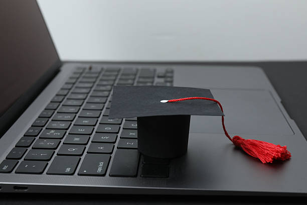 istock Graduation concept. Flat lay square academic cap with diploma and book on white background. 2250655853