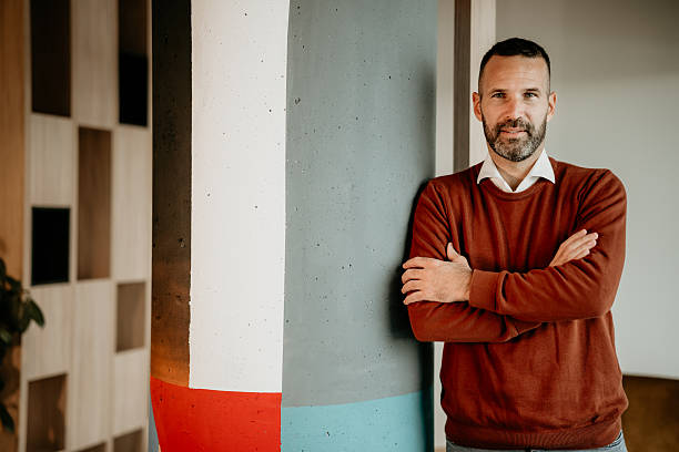 istock Confident mid adult man with beard standing in office 2250656548
