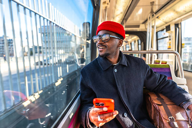 istock Young man commuting on public transport checking smart phone 2250656940