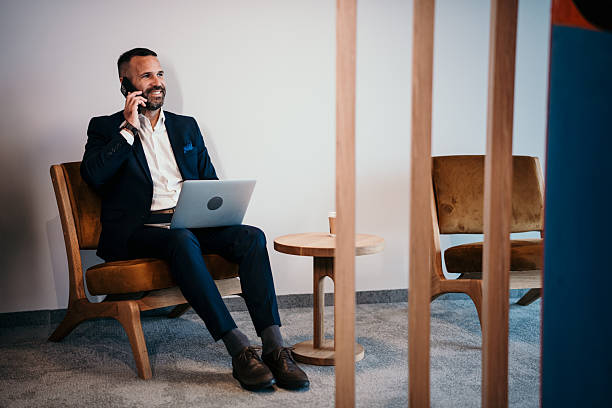 istock Professional businessman talking on phone using laptop 2250656979