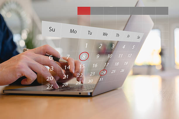 istock Hands using laptop with digital calendar overlay showing marked dates, representing online scheduling, appointment booking, time management, reminder planning and productivity workflow. 2250657166