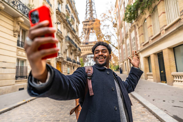 istock Happy man traveling paris taking selfie with eiffel tower 2250657404