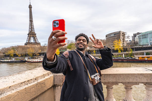 istock Happy traveler taking selfie with eiffel tower in paris 2250657430