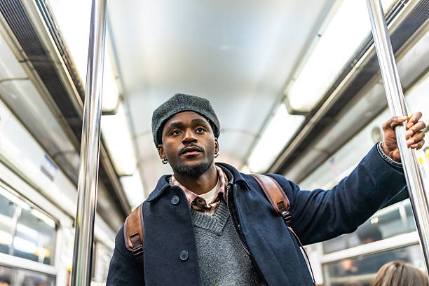 istock Young adult man commuting on subway looking thoughtful 2250657663