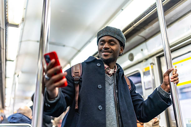 istock Young adult black man commuting on subway using phone 2250657686