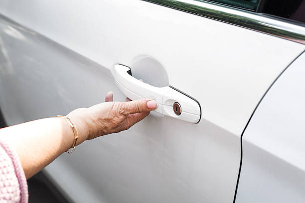 istock Woman hand opening white car door handle closeup with copy space, representing access, transportation, travel, security, everyday mobility and automotive lifestyle concept 2250658629