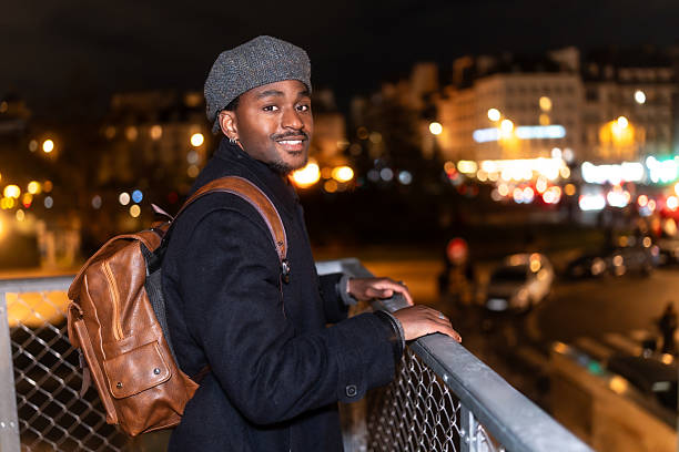 istock Young black man traveling paris at night 2250658685